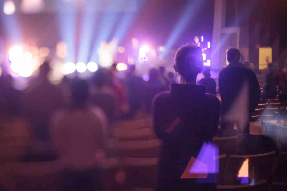 A photo of a concert-goer listening to music