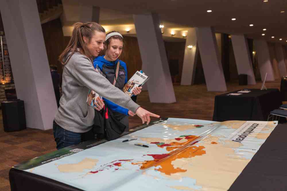 A photograph of two students looking at a campaign map